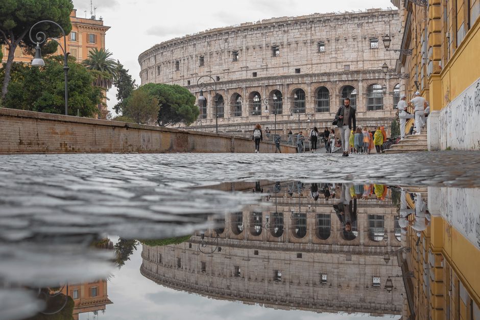 Travelers on a guided tour inside the Colosseum in Rome, Italy