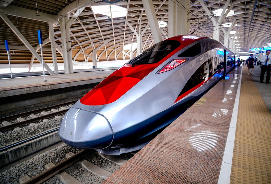 A sleek Frecciarossa high-speed train speeding through the Italian countryside