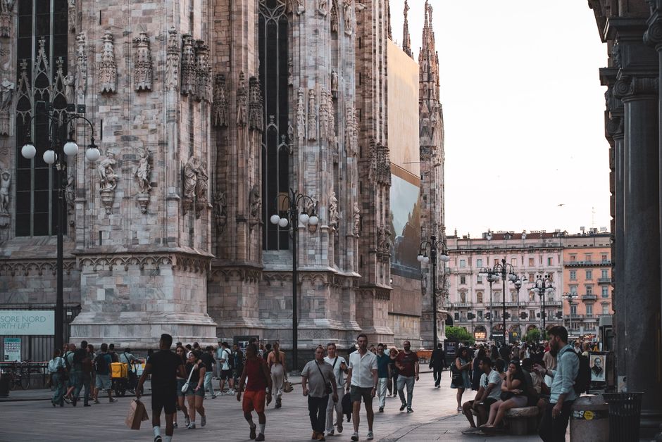 Tourists enjoying a historic street in Italy, symbolizing worry-free travel with insurance