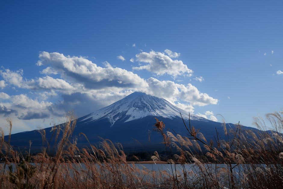 Car driving on a scenic road in Japan with Mount Fuji in the background
