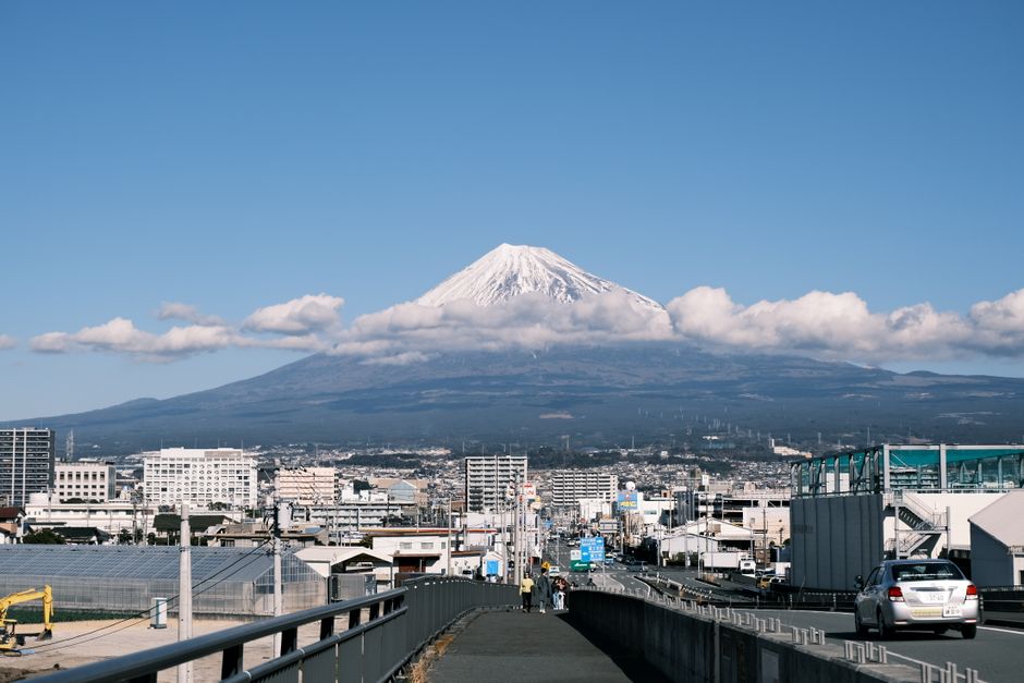 Scenic train journey through the Japanese countryside with Mount Fuji visible in the distance