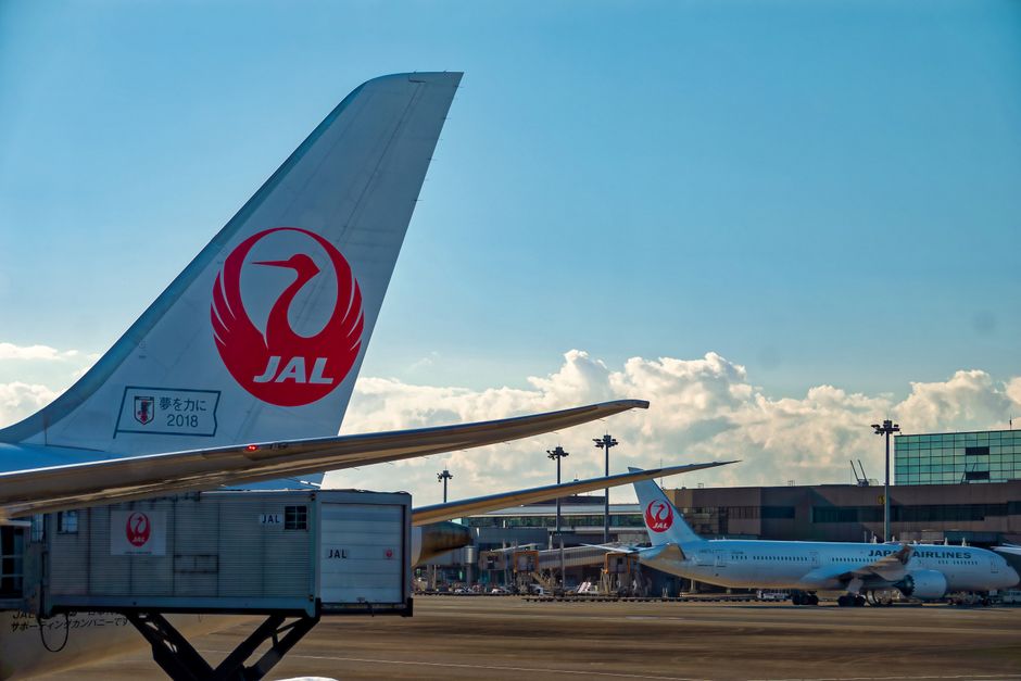 Japan Airlines plane at a modern airport terminal in Tokyo, Japan
