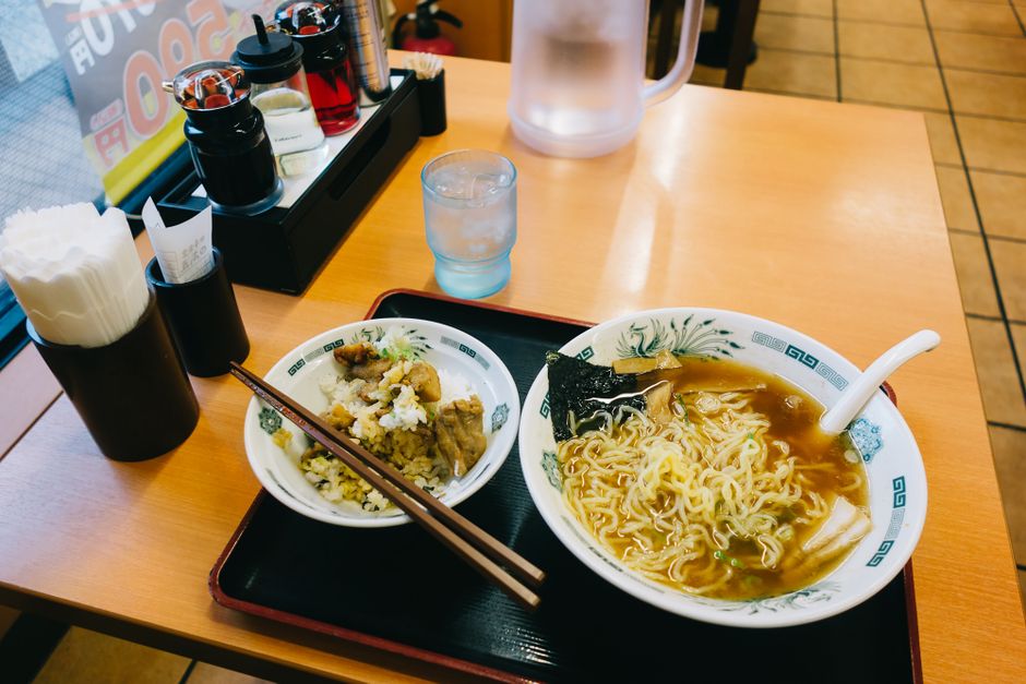 A steaming bowl of traditional Japanese ramen with chopsticks in Tokyo