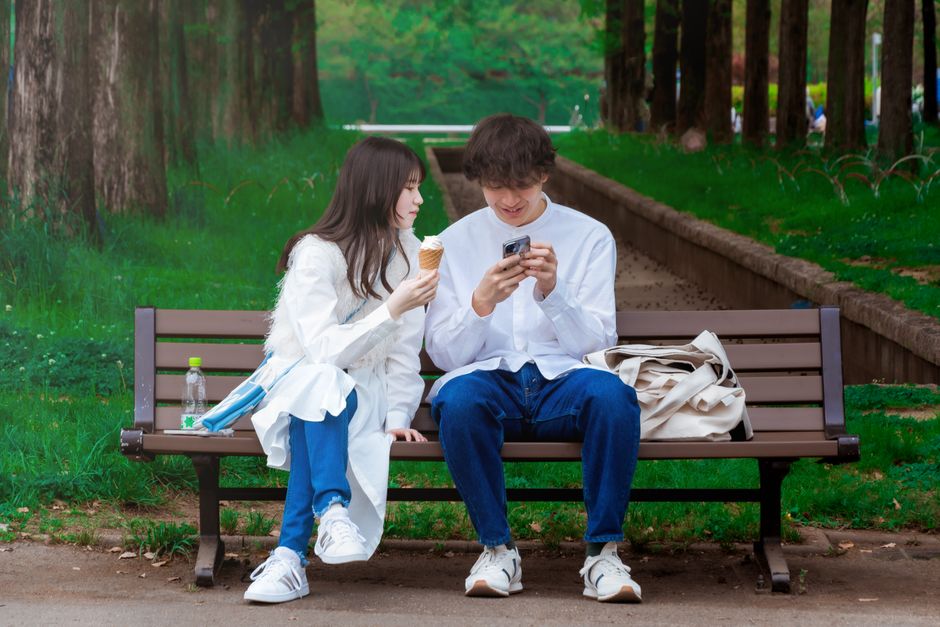 Traveler using a smartphone with a vibrant Tokyo city skyline in the background, symbolizing internet connectivity in Japan.