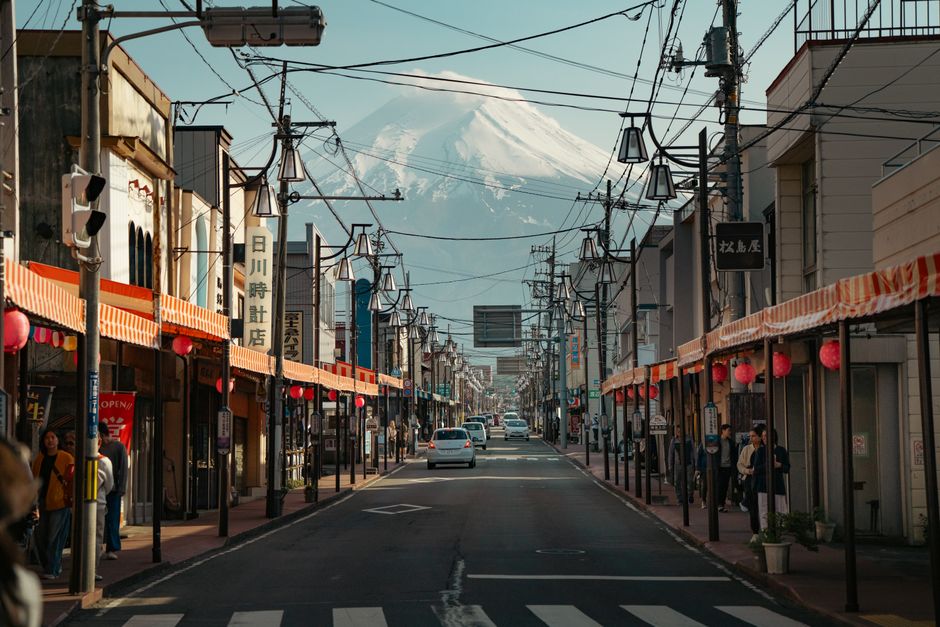 Mount Fuji with cherry blossoms and a tour group in Japan