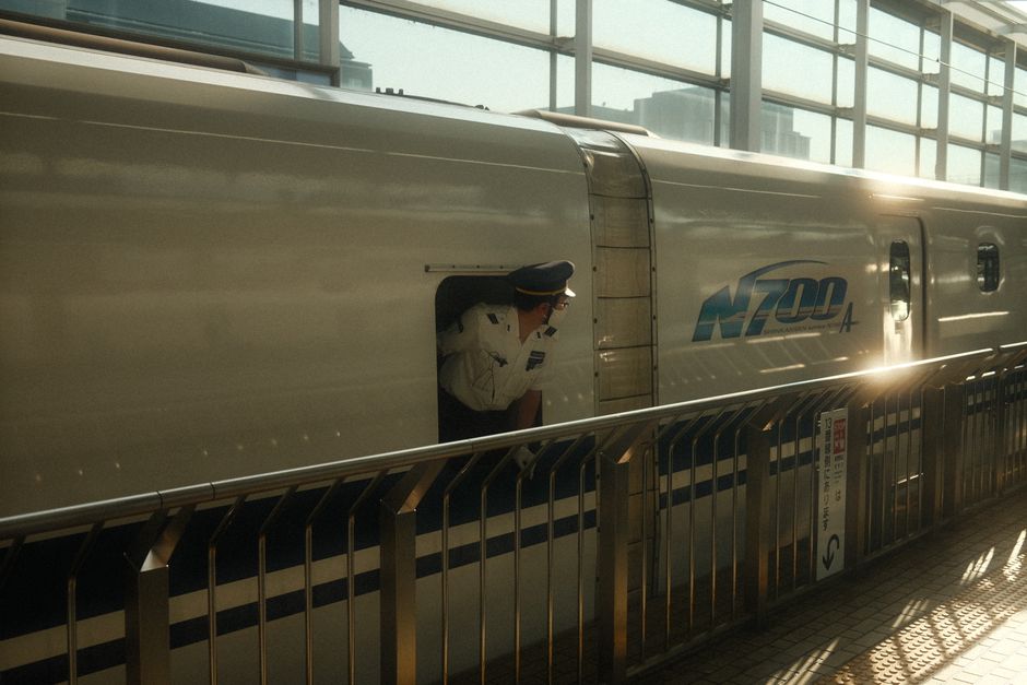 High-speed Shinkansen bullet train arriving at a station in Japan