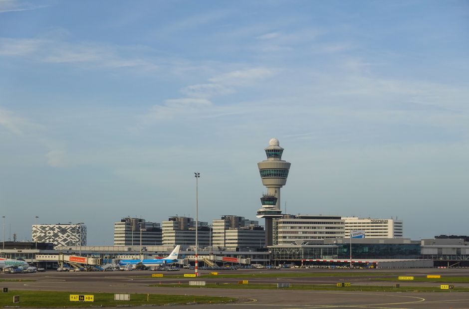 Exterior view of Riga International Airport in Latvia with planes on the tarmac.