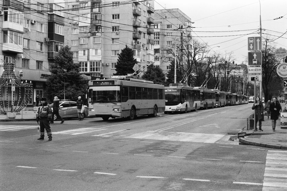 A modern trolleybus on a street in Vilnius, Lithuania, with historic buildings in the background, symbolizing efficient city transport.