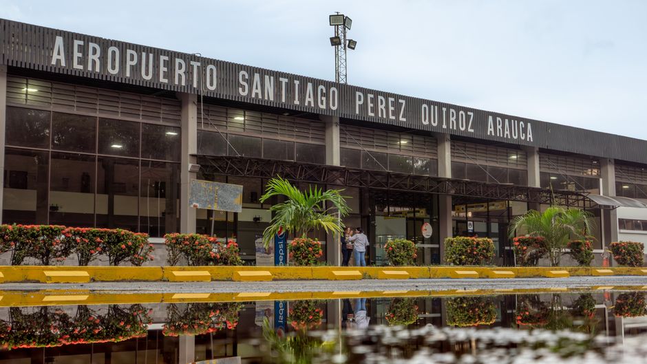 Busy terminal at Mexico City International Airport with travelers and airplanes