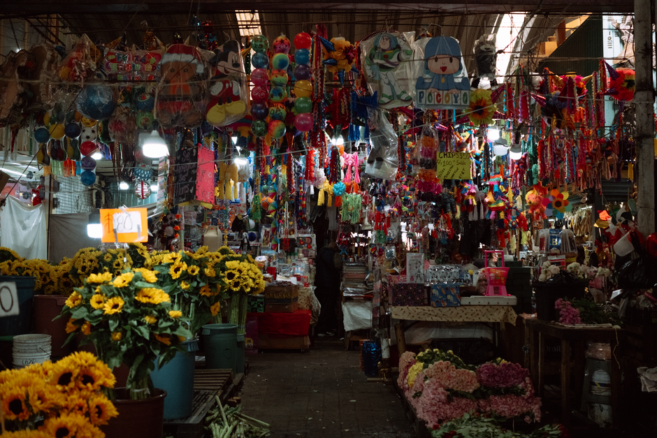 A bustling street market in Mexico City, showcasing fresh produce and local life, symbolizing affordable travel.