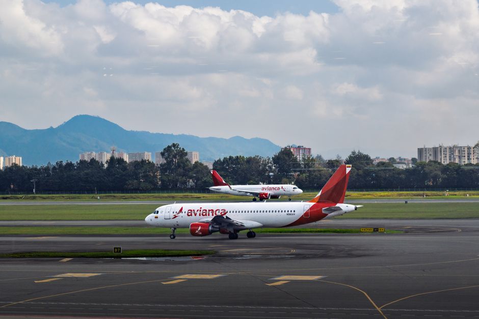 Bustling terminal at Mexico City International Airport with planes visible