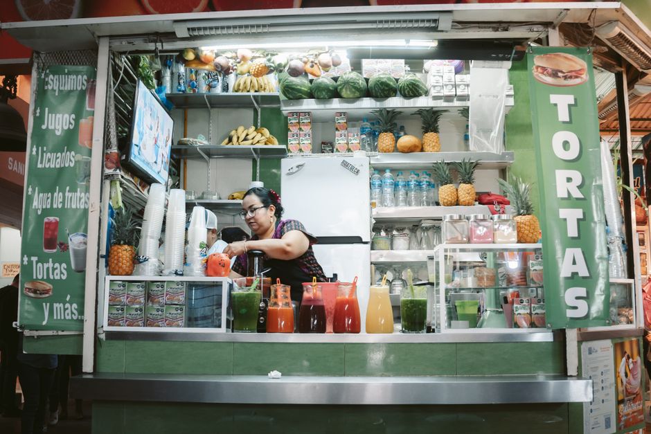 Vibrant Mexican street food stall with tacos, fresh ingredients, and a bustling atmosphere.