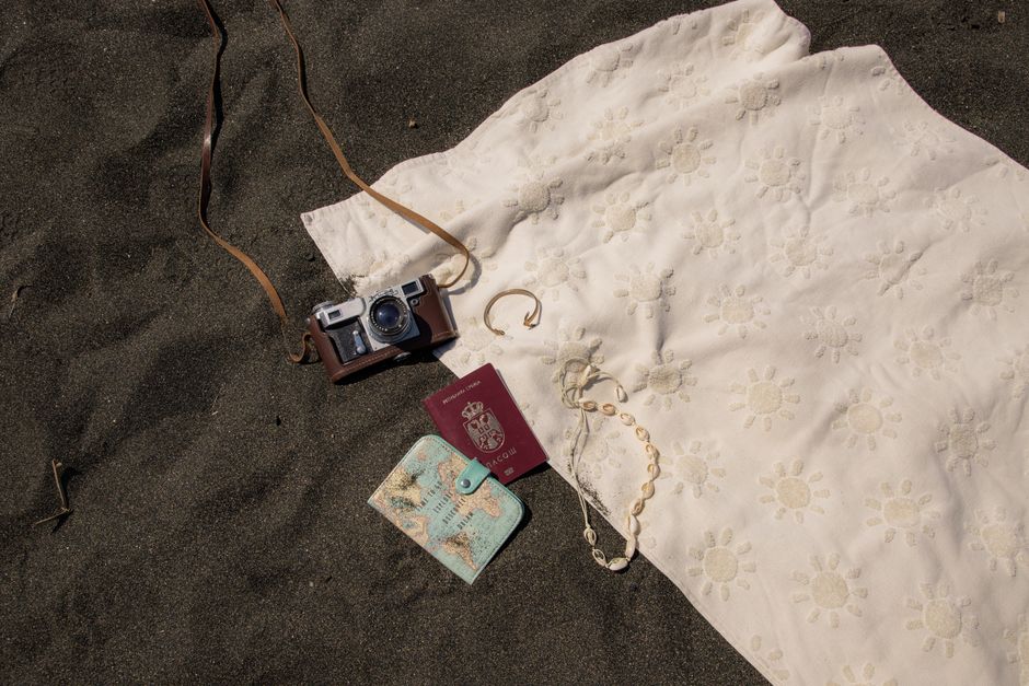 A neatly packed suitcase with beachwear, sunscreen, and a travel adapter for a Mexico trip