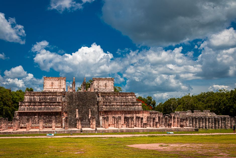 Tourists exploring the ancient Mayan ruins of Chichen Itza in Mexico