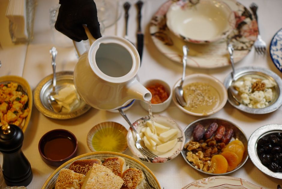 A vibrant spread of traditional Moldovan dishes, including plăcinte and mămăligă, on a rustic table in Moldova.