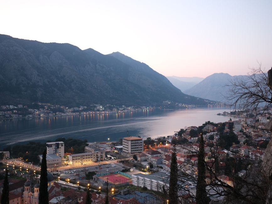 Stunning sunset view over the Bay of Kotor in Montenegro, with ancient towns nestled along the coastline