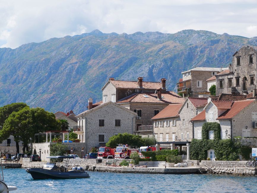 Car driving along a beautiful coastal road in Montenegro with mountains and sea