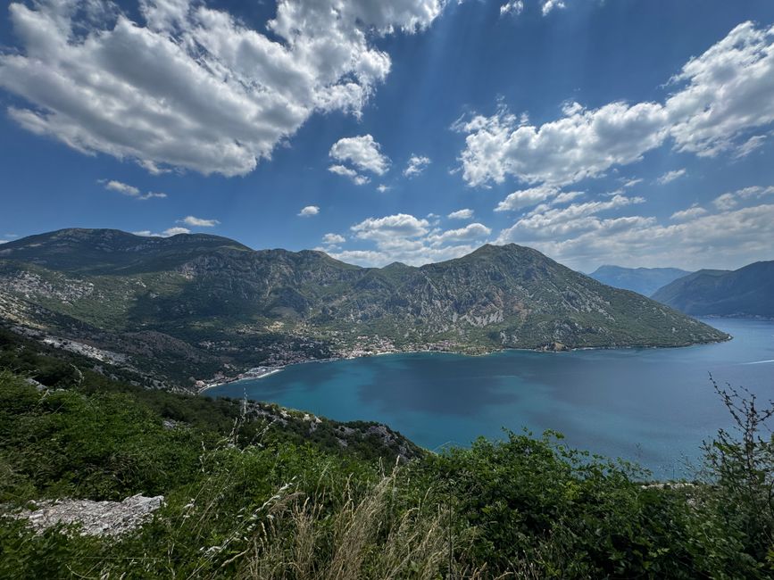 Panoramic view of Montenegro's stunning coastline with clear blue waters and mountains
