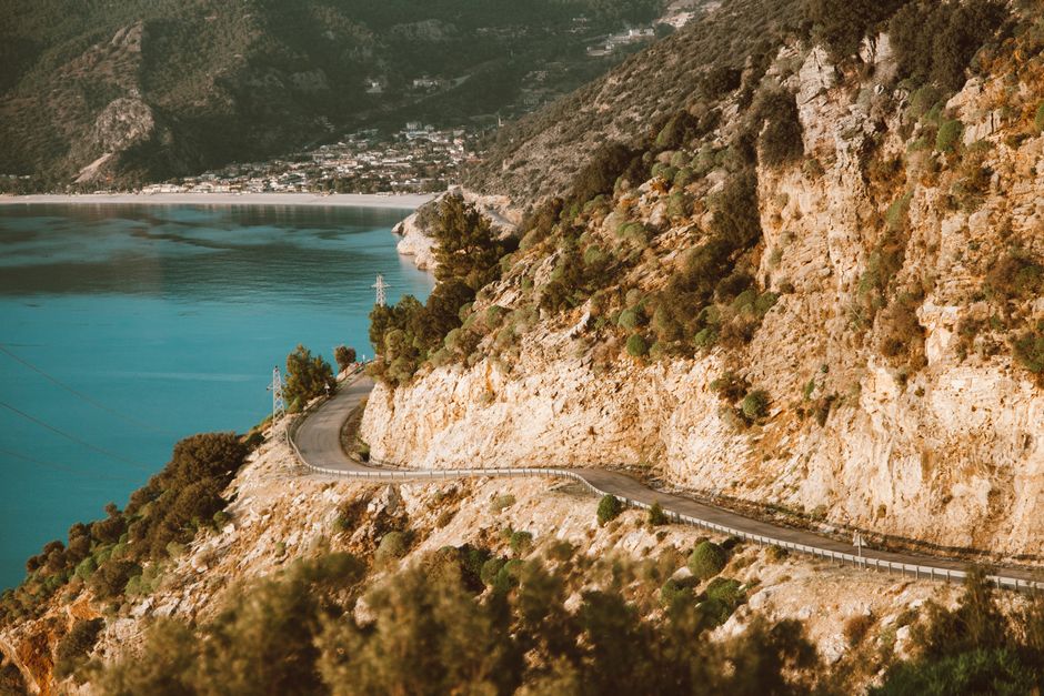 Scenic coastal road in Montenegro with a car driving, overlooking the Adriatic Sea