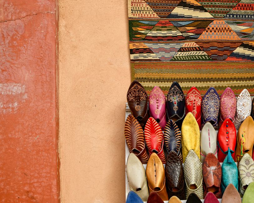 A bustling souk in Marrakech, Morocco, with colorful spices and artisanal goods, representing the vibrant local culture.