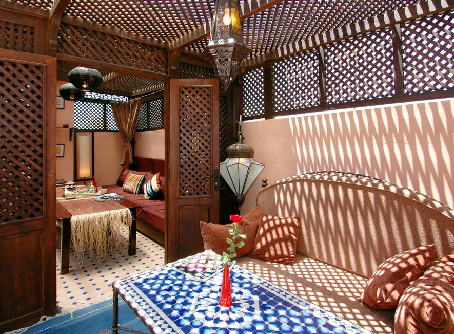 Beautiful traditional riad courtyard in Marrakech, Morocco with mosaic tiles and a fountain