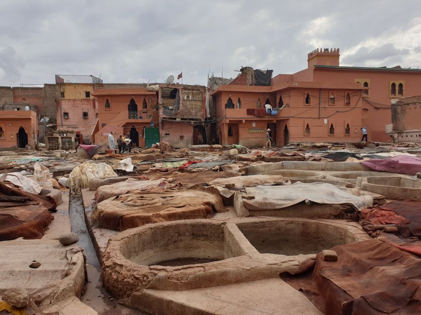 Vibrant market scene in a Marrakech souk, Morocco, with colorful stalls and shoppers.