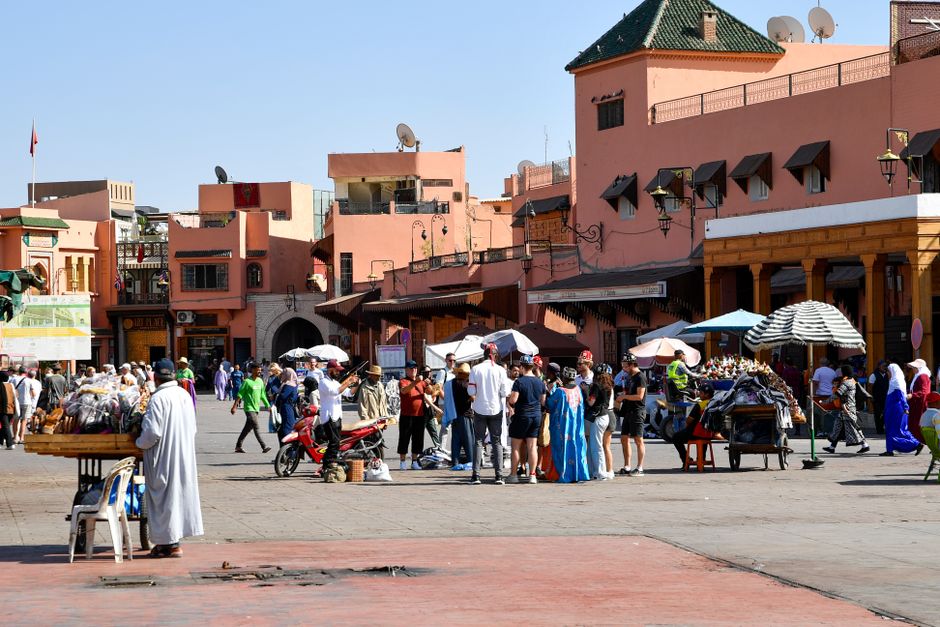 A modern train station in Morocco with travelers waiting for an ONCF train