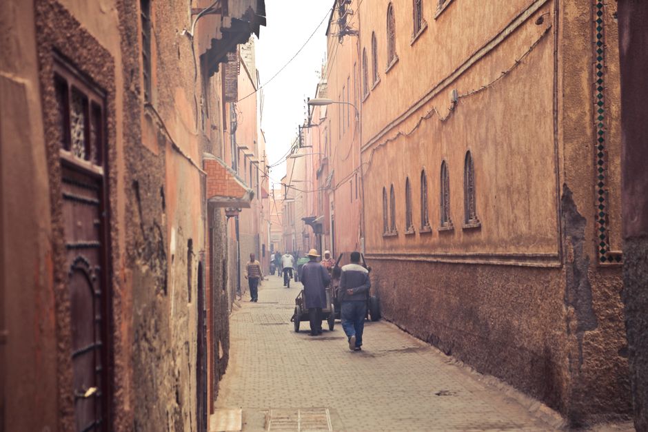 Travel insurance policy document with a vibrant Moroccan market in the background