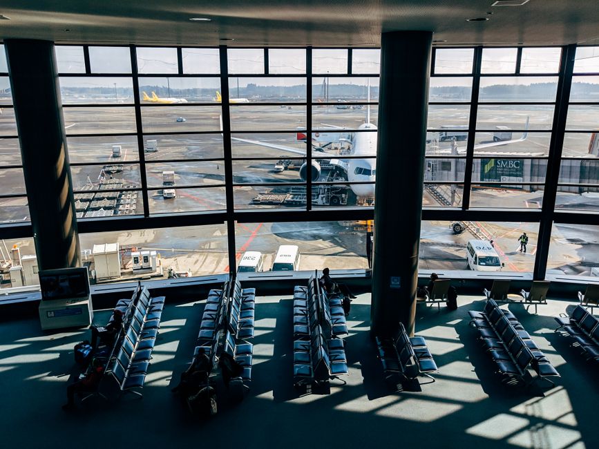 Modern terminal building of Auckland Airport in New Zealand with planes on the tarmac