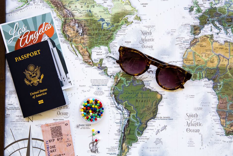 Traveler planning a New Zealand itinerary with a map and various transport options