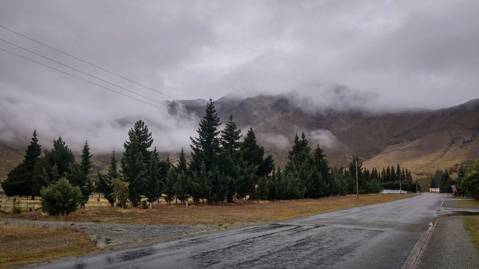 Stunning New Zealand landscape with a winding road through mountains and valleys, inviting regional exploration
