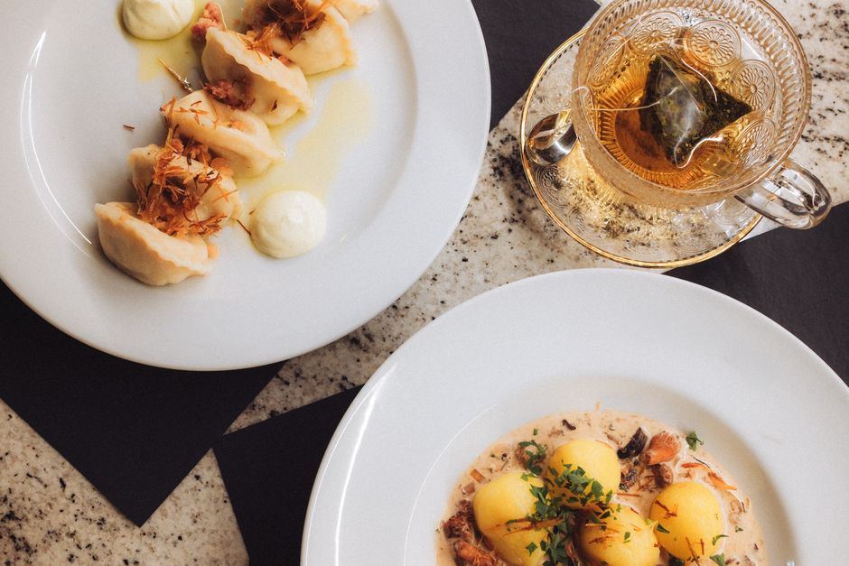 A vibrant spread of traditional Polish dishes including pierogi, bigos, and kotlet schabowy on a wooden table in Poland