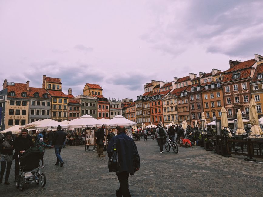 Tourists exploring the historic Main Market Square in Krakow, Poland
