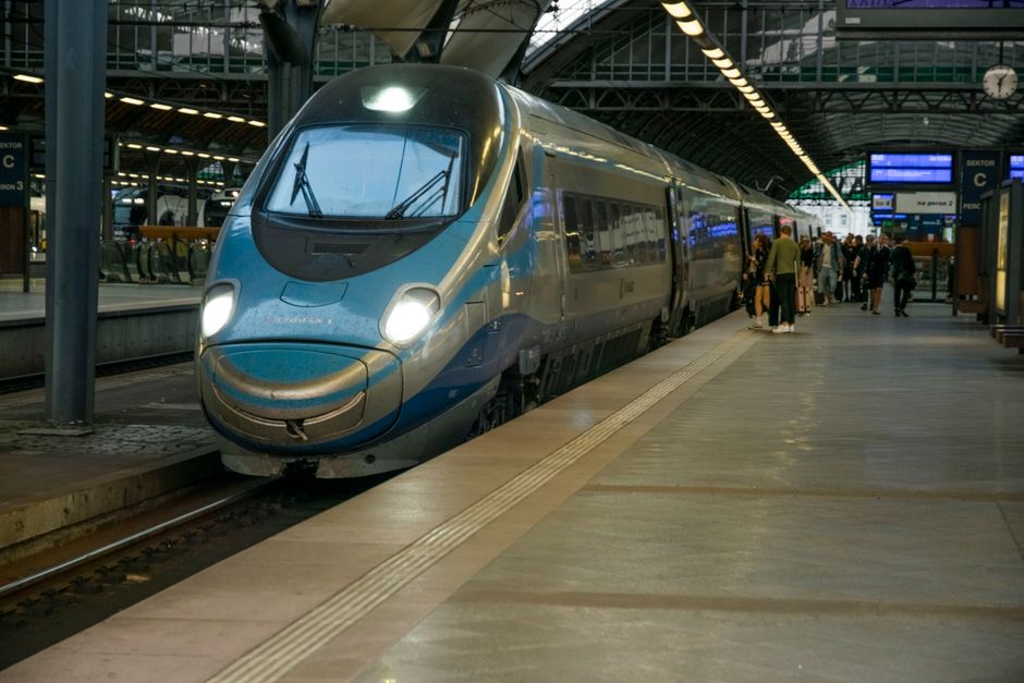 Modern train station in Poland with travelers and trains