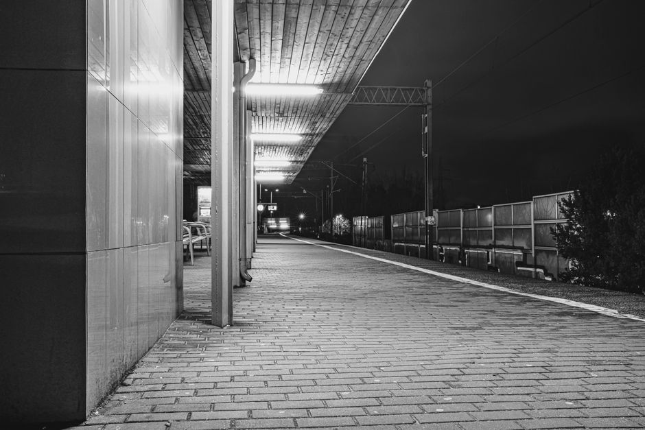Modern train station platform in Poland with a high-speed train arriving.