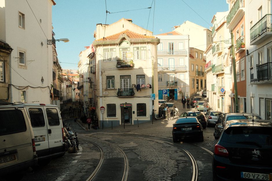 Iconic yellow tram on a charming street in Lisbon, Portugal, with historic buildings