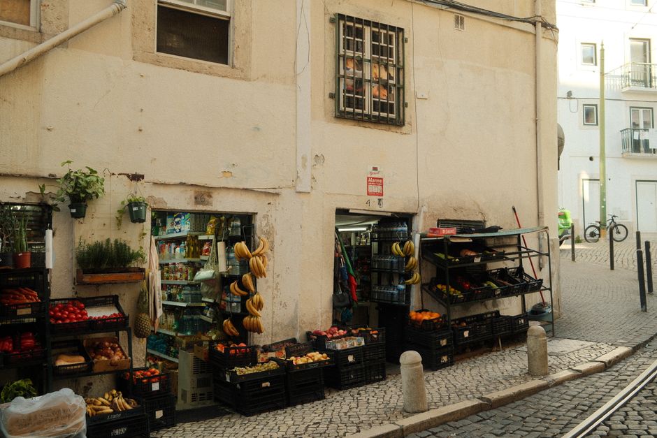Bustling shopping street in Lisbon, Portugal with people browsing stores