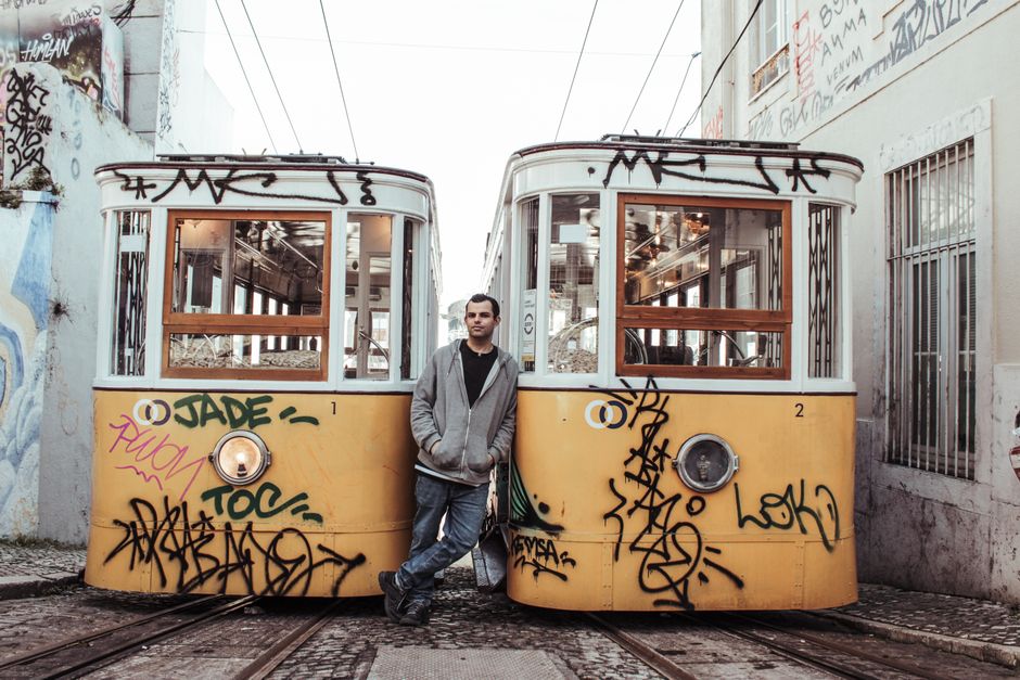 Historic yellow tram winding through a narrow street in Lisbon, Portugal