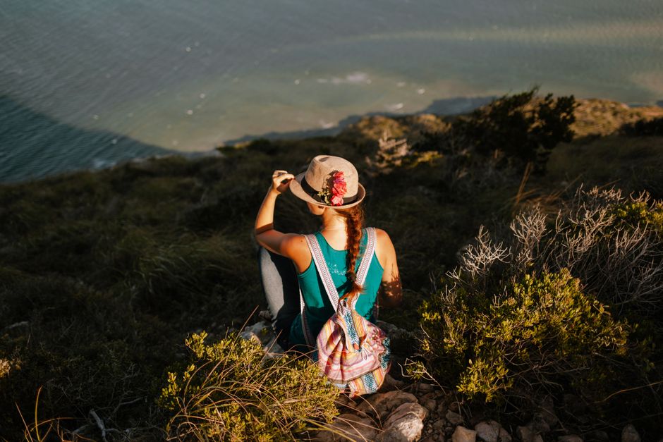 Traveler looking at the beautiful Portuguese coastline, symbolizing a safe and enjoyable trip to Portugal with travel insurance.