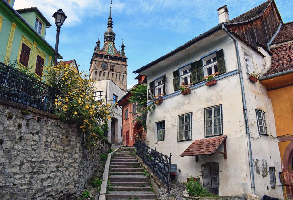 Traditional Romanian guesthouse with flowers, inviting accommodation in rural Romania