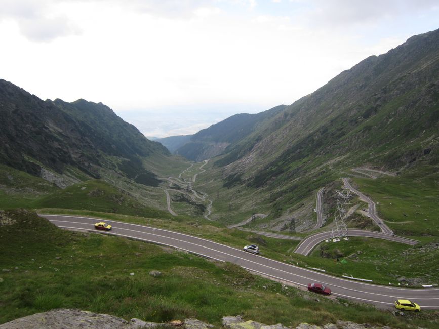 Dacia Logan rental car driving on the Transfagarasan road in Romania