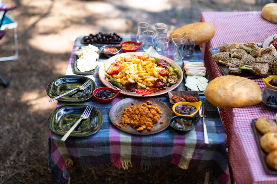 A vibrant spread of traditional Romanian dishes like sarmale, mici, and ciorbă on a rustic table in Romania