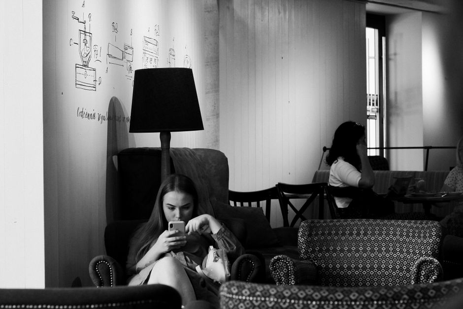 Traveler using smartphone with fast internet in a cafe in Bucharest, Romania