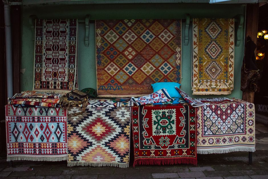 Shoppers browsing colorful stalls at a traditional Romanian market