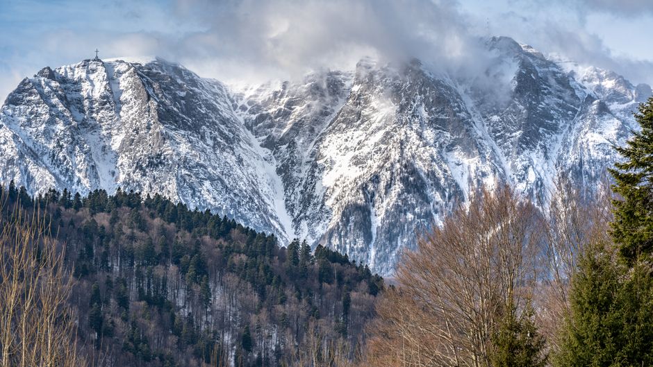 Diverse Romanian landscapes showcasing varied weather, from sunny fields to snowy mountains