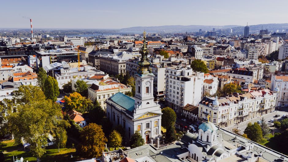 Bustling street scene in Belgrade, Serbia, with historic architecture and people walking