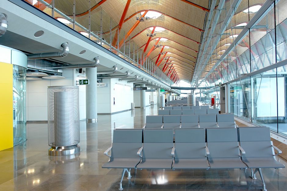 Modern airport terminal at Belgrade Nikola Tesla Airport in Serbia with planes visible through large windows