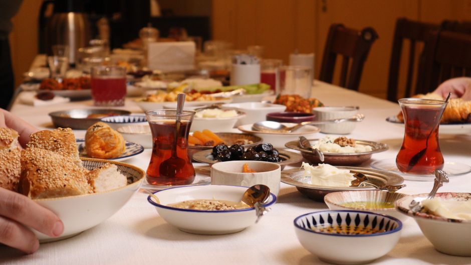 A vibrant spread of traditional Serbian dishes including ćevapi, kajmak, and fresh salads on a wooden table in Belgrade.