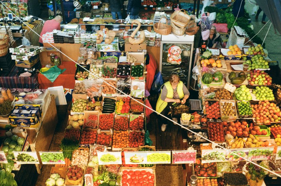A vibrant traditional green market in Belgrade, Serbia, with stalls selling fresh produce and local goods