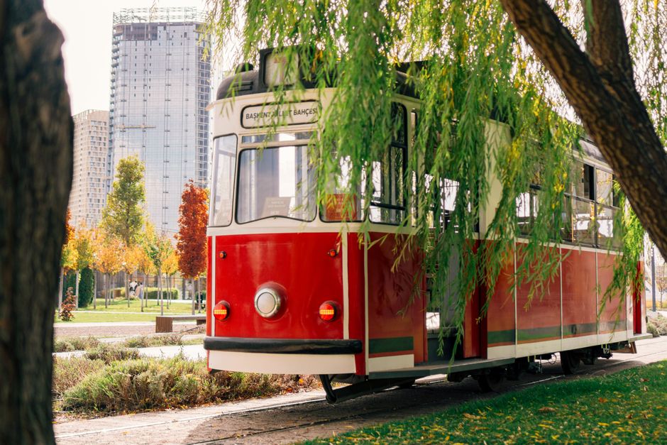 A modern tram moving through a bustling street in Belgrade, Serbia, with historic buildings in the background.